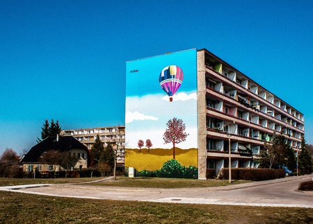 Schwedt Oder, Germany - March 10, 2014  A colorful mural on a residential building It draws attention colorful flying balloon のeditorial素材