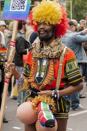 BERLIN, GERMANY - JUNE 21, 2014: Christopher Street Day. Crowd of people Participate in the parade celebrates gays, lesbians, bisexuals and transgenders. Prominent in the image, funny dressed participantのeditorial素材