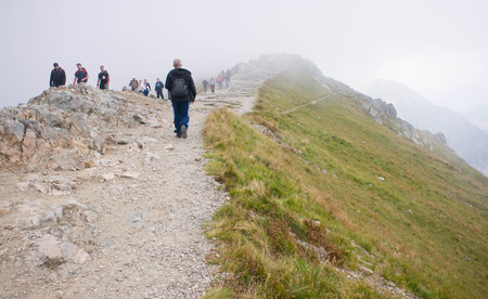 ZAKOPANE, POLAND - SEPTEMBER 05, 2014: Path on the steep side of Kasprowy Wierch in Tatra mountains and a view of the border between Poland and Slovakia.のeditorial素材