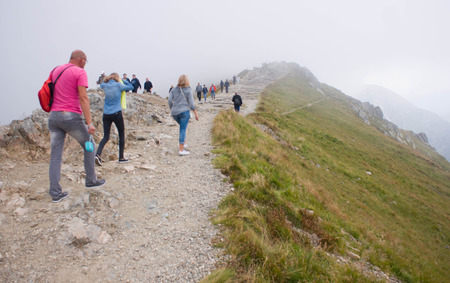 ZAKOPANE, POLAND - SEPTEMBER 05, 2014: Path on the steep side of Kasprowy Wierch in Tatra mountains and a view of the border between Poland and Slovakia.のeditorial素材