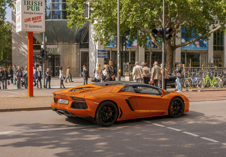 BERLIN, GERMANY - MAY 30, 2014: Orange supercar Lamborghini at the city streetのeditorial素材