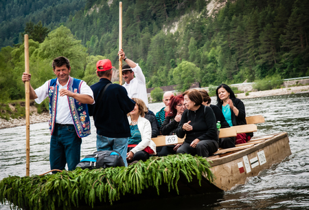 DUNAJEC RIVER, POLAND - JUNE 26, 2015: Tourists raft on the Dunajec river, south of Poland. The rafting near the slovakian border is very popular tourist attraction.のeditorial素材
