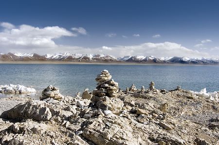 buddish mani stone piles at lake sideの写真素材