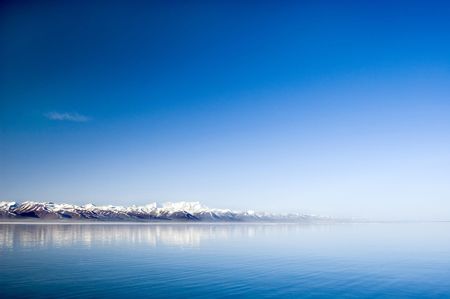 tranquil lake and snow mountains in the morningの写真素材