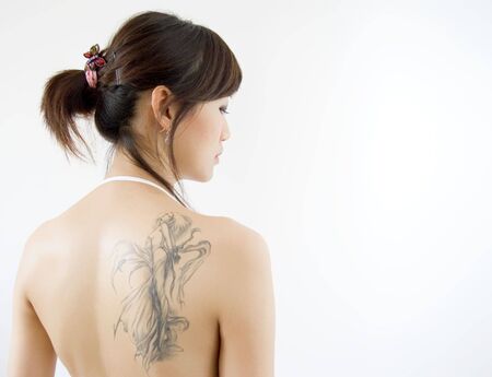 rear view of adult woman with tattooの写真素材