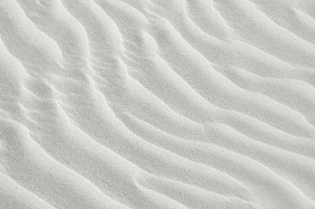 white sea sand texture on sunset