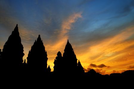 Hindu temple - Dramatic sky with sun setting at Hindu temple Prambanan. Indonesia, Central Java, Yogyakartaの写真素材
