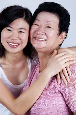 Happy Asian Family. Daughter hugging her mother.の写真素材