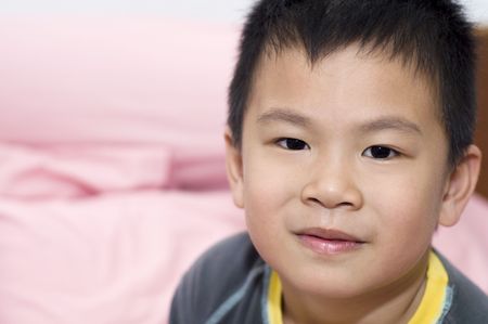 Photo of Asian young boy looking at camera.の写真素材