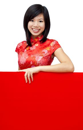Oriental girl with traditional Cheongsam holding a red blank card.の写真素材
