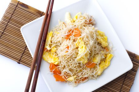 Asian fried rice vermicelli with eggs and carrot. Serve with chopsticks.の写真素材