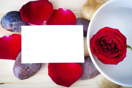 Rose, pebble and a blank card.の写真素材
