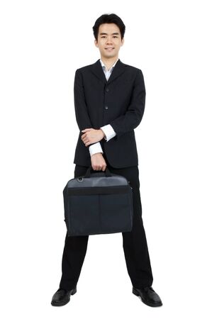 Full body of a smiling Asian businessman standing against isolated white backgroundの写真素材