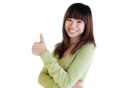 Young Asian female giving thumbs up sign.の写真素材