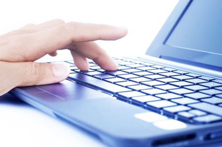 Closeup of a hand typing on laptop keyboard.の写真素材