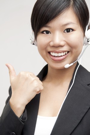 Thumb up Friendly Customer Representative with headsetの写真素材