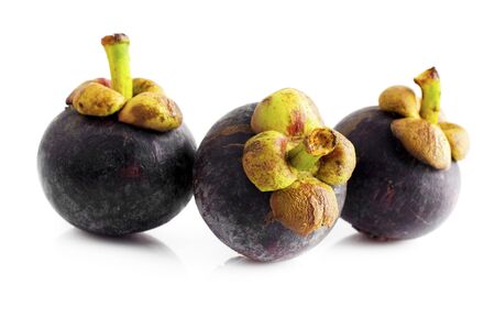 Three mangosteens fruit isolated on white backgroundの写真素材