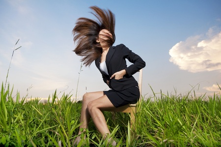 Outdoor Fashion businesswoman tossing her hair in airの写真素材