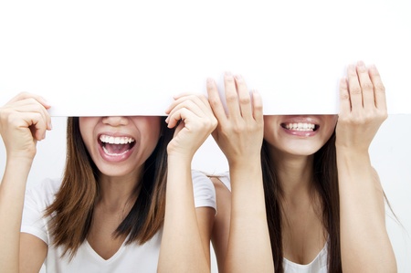 Concept photo of Asian women holding a white card, covering eyes.の写真素材