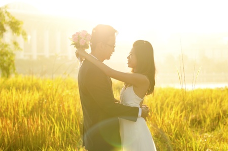 Outdoor Bride and Groom, surrounding by natural morning golden sunlight.の写真素材