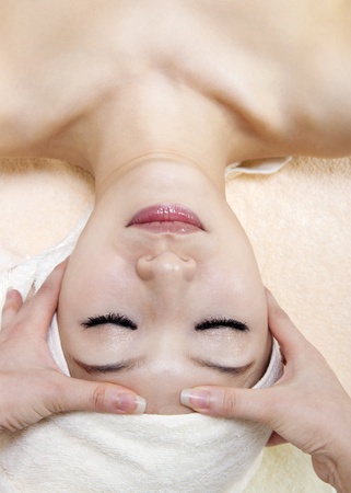 Beauty and Spa - Asian Girl having a massage on her headの写真素材