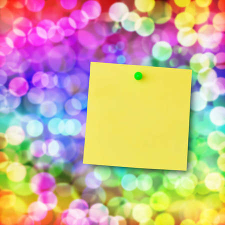 Sticky note on glowing colorful magical neon light background.