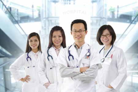 Asian medical team standing inside hospital buildingの写真素材