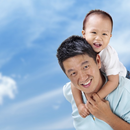 Outdoor Asian family over blue skyの写真素材