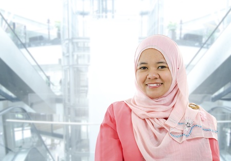 Asian Muslim woman standing on modern office backgroundの写真素材