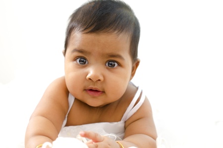 Adorable 6 months old Indian baby girl looking at cameraの写真素材