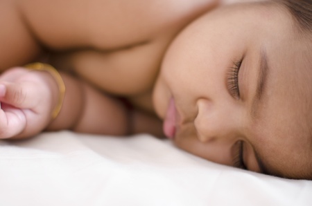 Adorable 6 months old Indian baby girl in deep sleep