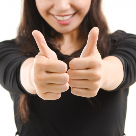 Young Asian female giving thumbs up sign isolated on white backgroundの写真素材