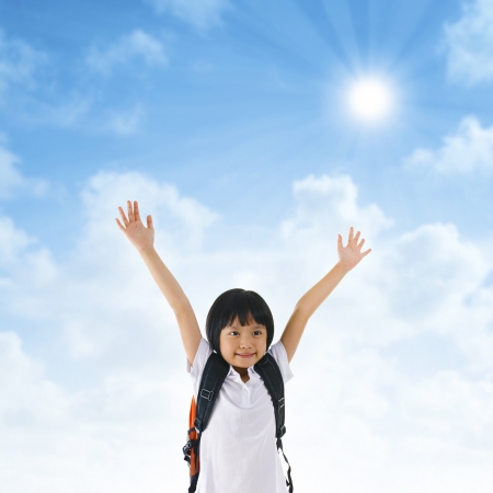 7 years old pan Asian school girl arms up in the airの写真素材