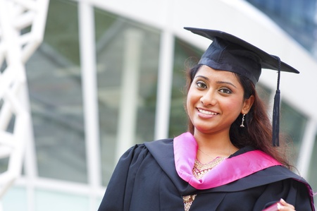 Stock image of Indian female graduate student standing in front school buidingの写真素材