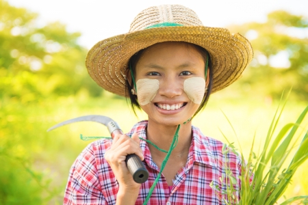 Portrait of a Burmese woman with thanaka powdered face who works in the fieldの写真素材