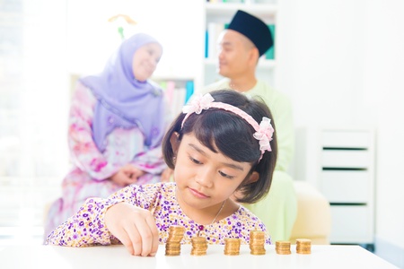 Southeast Asian girl money savings concept. Asian family living lifestyle.の写真素材