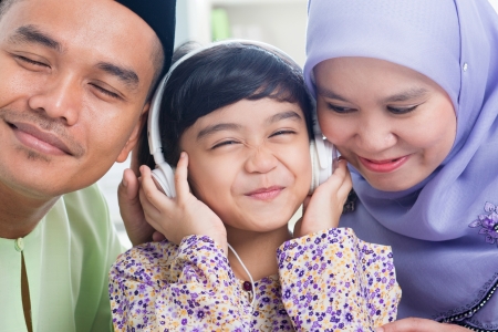 Southeast Asian family listen mp3, sharing headphone. Muslim family living lifestyleの写真素材