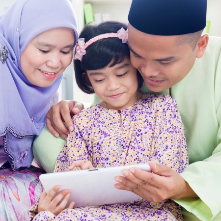 Southeast Asian family surfing internet at home. Muslim family living lifestyleの写真素材