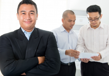 Southeast Asian business men in officeの写真素材