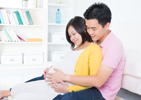 Asian couple. Husband and 8 months pregnant wife.の写真素材