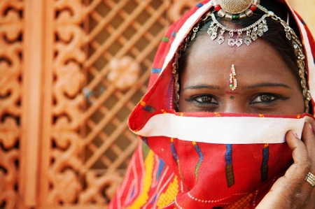 Traditional Indian woman in sari costume covered her face with veil, Indiaの写真素材