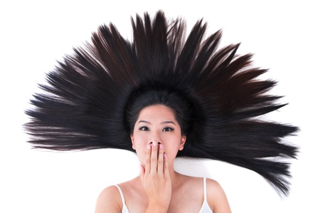 Beautiful young Asian girl lying on white with scatter hairの写真素材