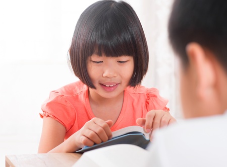 Southeast Asian children reading book at home, Asian family living lifestyle.の写真素材