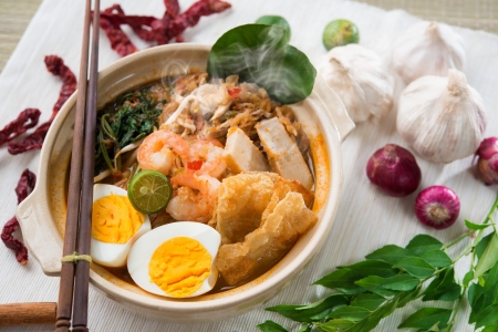 Prawn mee, prawn noodles. Famous Malaysian food spicy fresh cooked har mee in clay pot with hot steam, serve with chopsticks.の写真素材