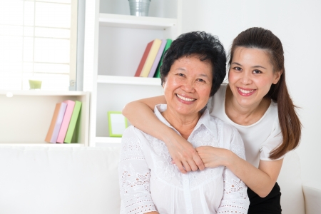 Happy Asian family senior mother and adult offspring having fun time at home.の写真素材