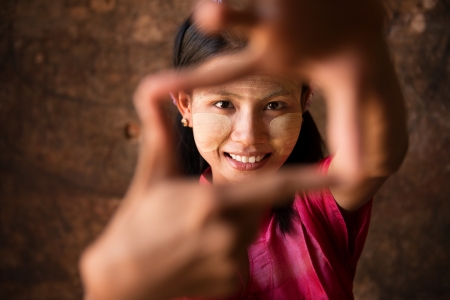 Beautiful young traditional Myanmar girl playing fun.の写真素材