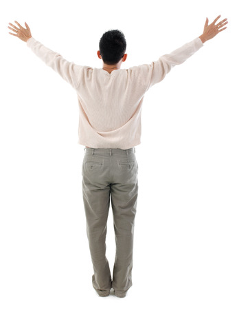 Rear view Asian man arms opened up. Full body standing isolated on white background. Asian male model.の写真素材