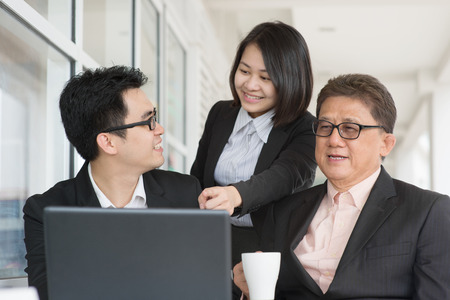 Asian business team meeting. Group of businesspeople having discussion at restaurant cafe.の写真素材
