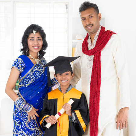 Kindergarten graduation. Asian Indian family, parents and child on kinder graduate day.の写真素材