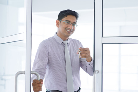 Asian Indian property agent handover new office key.の写真素材
